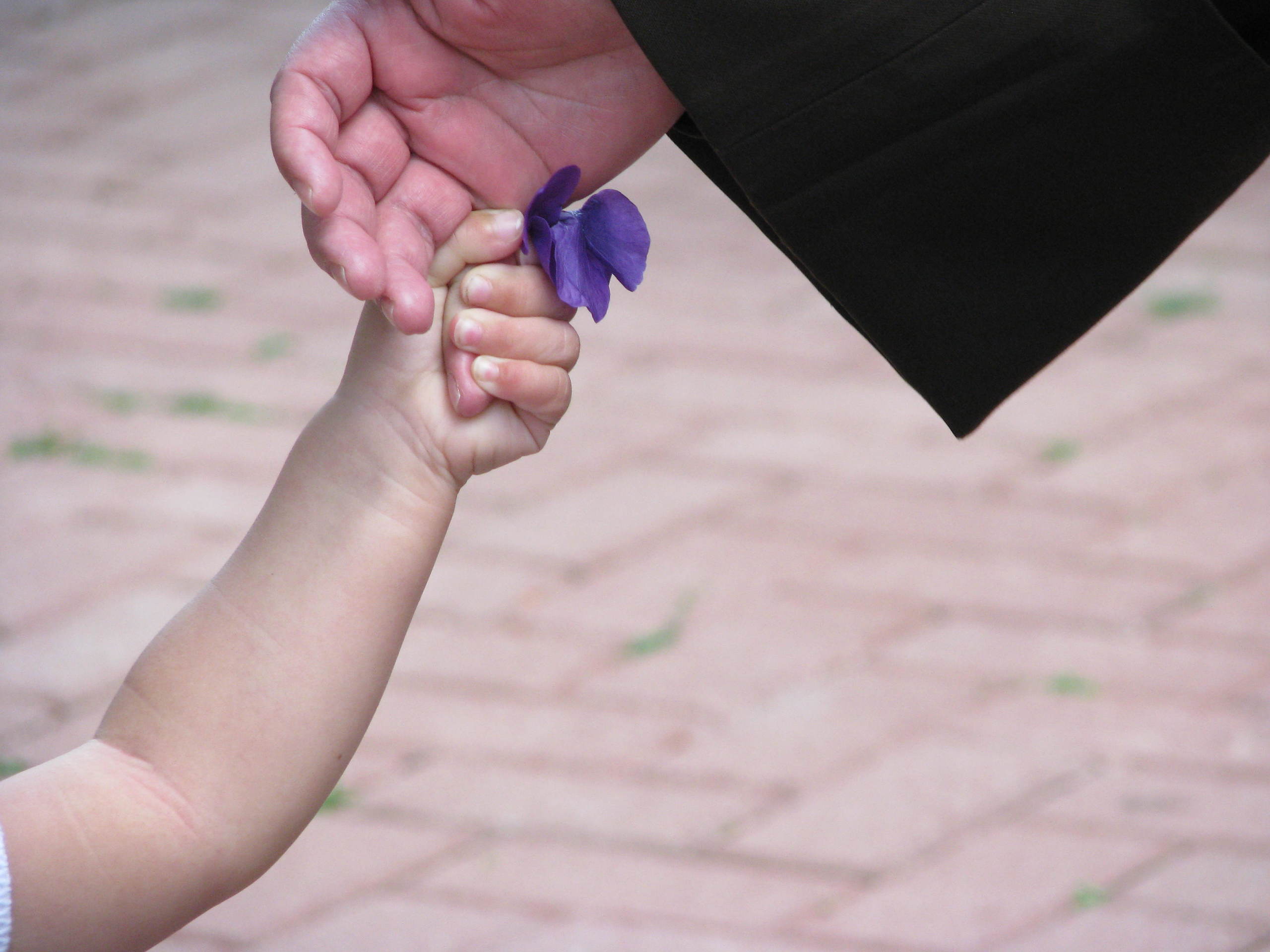 child holding a Sister's hand