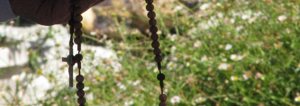 Sister holding a rosary outside