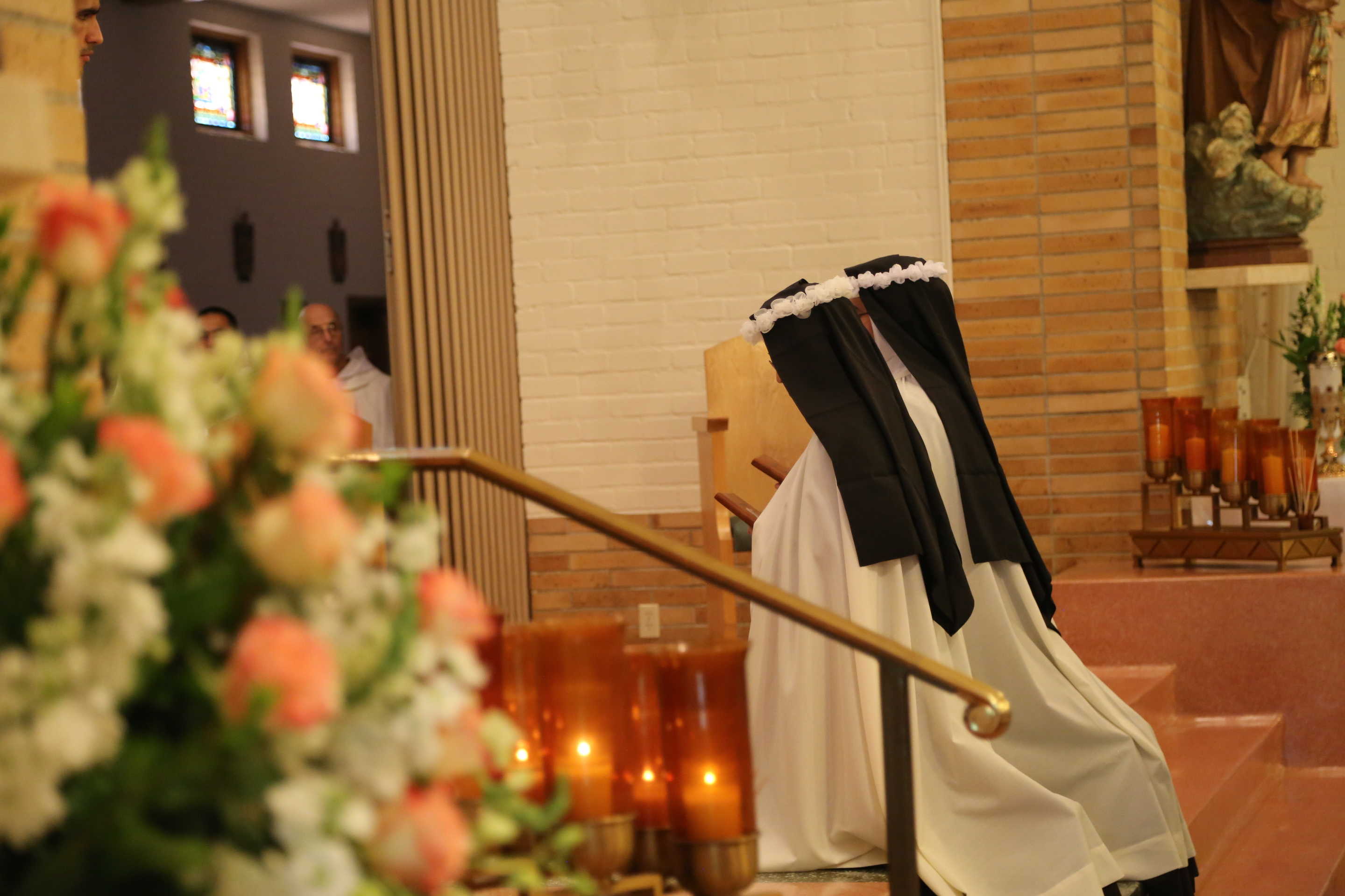 Two Sister kneeling in front of altar
