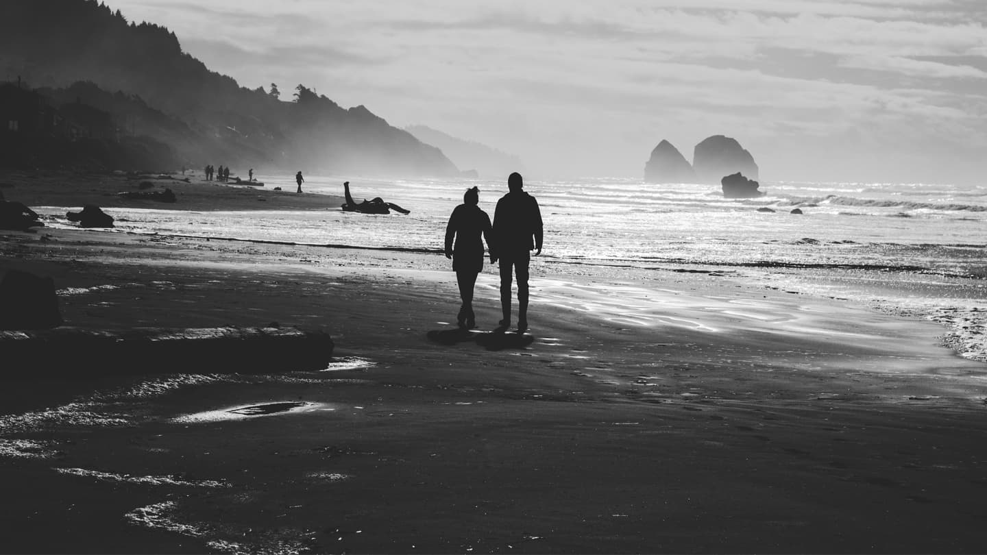 couple walkind down beach, oceanside