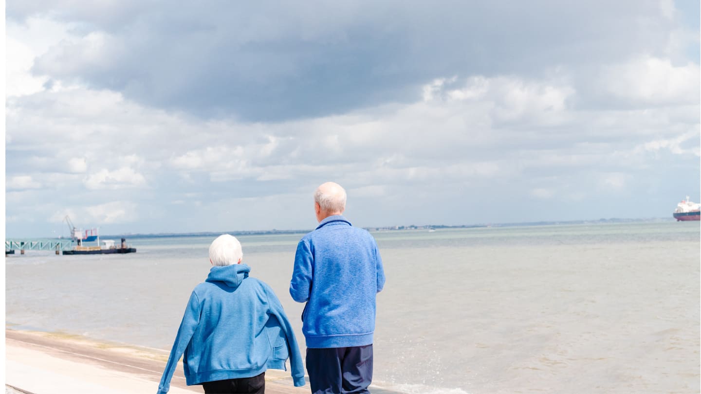seniors walking down beach