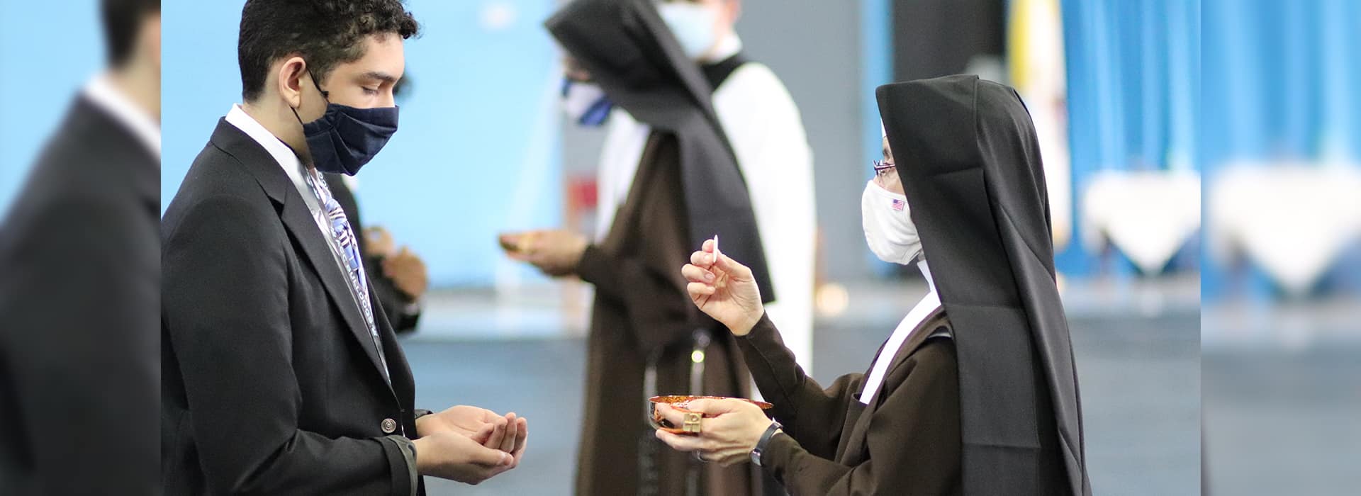 Lay man receiving Eucharist from Sister