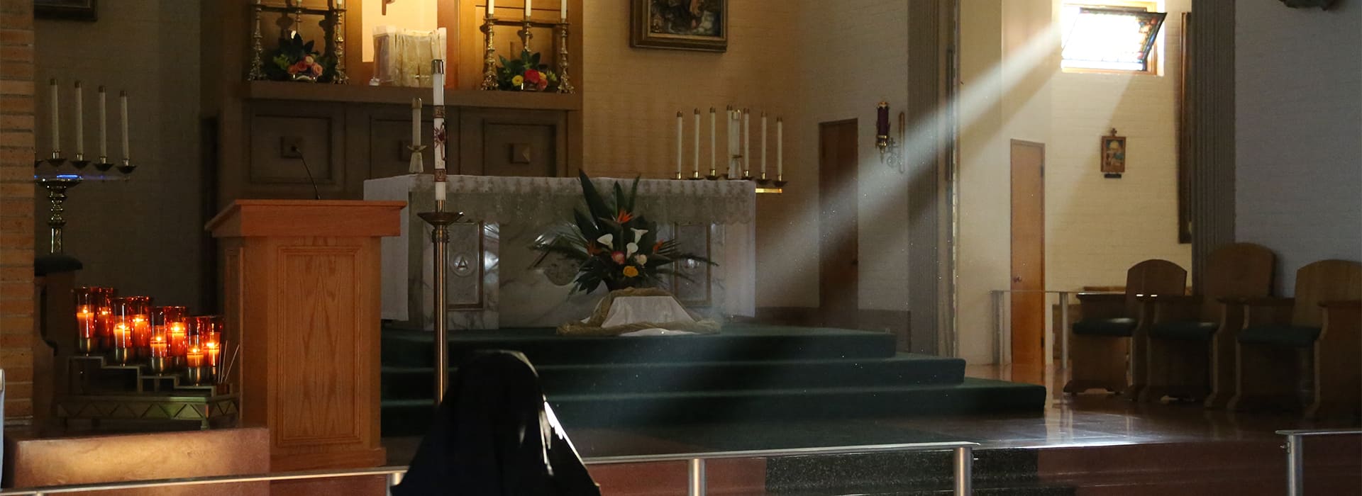Sunlight shining on Sister praying in chapel