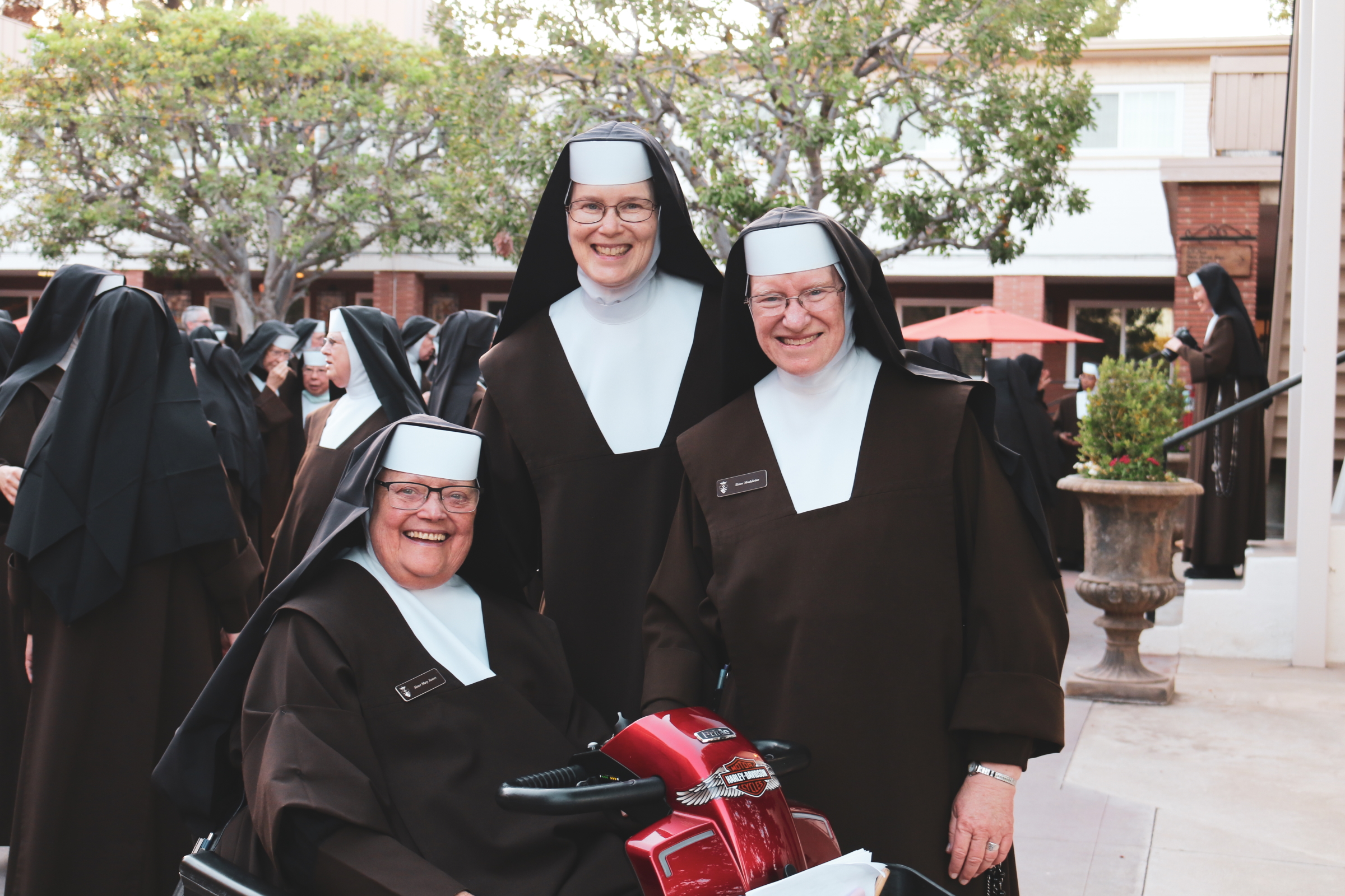 3 Sisters smiling for a photo during community event