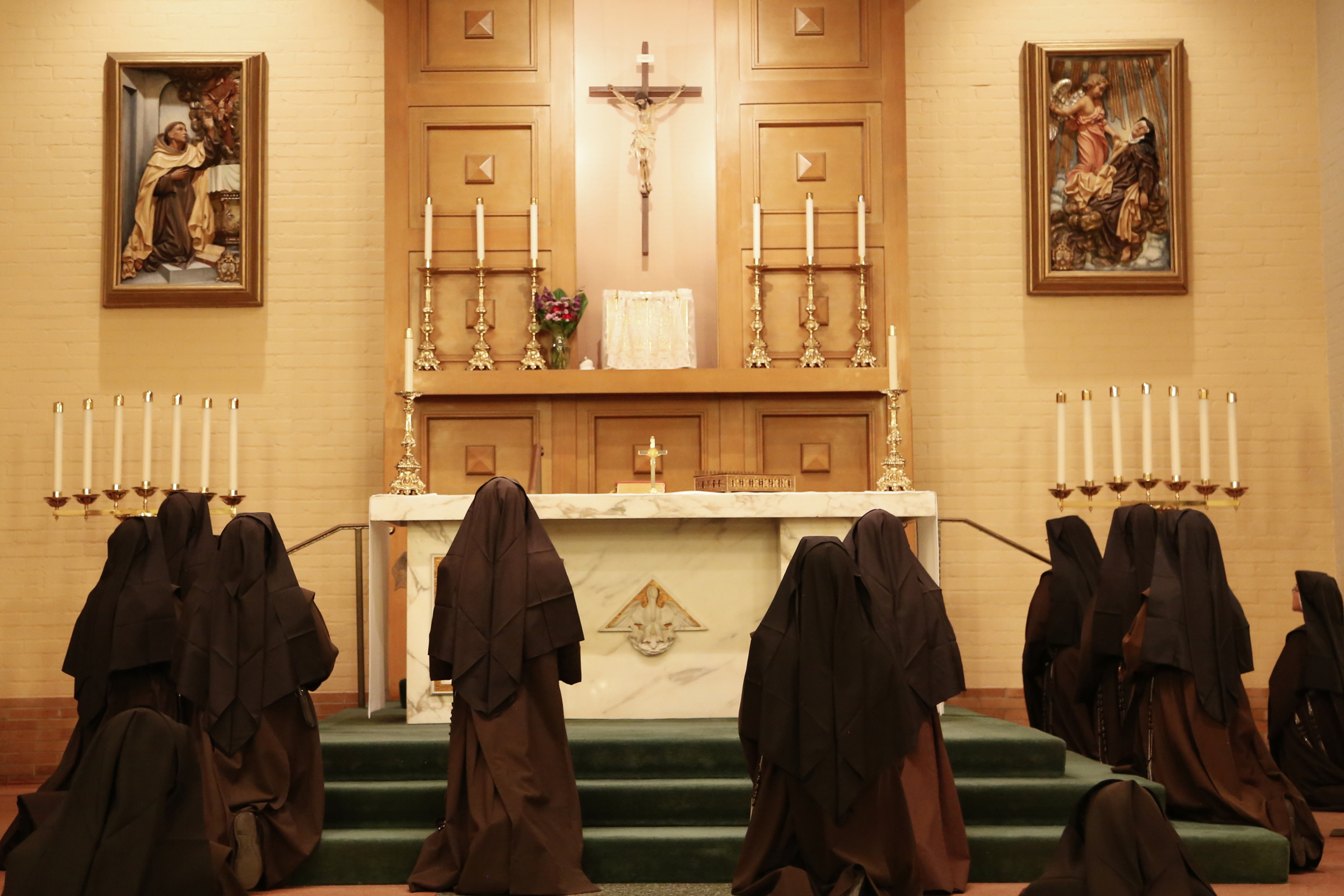 Sisters kneeling at altar