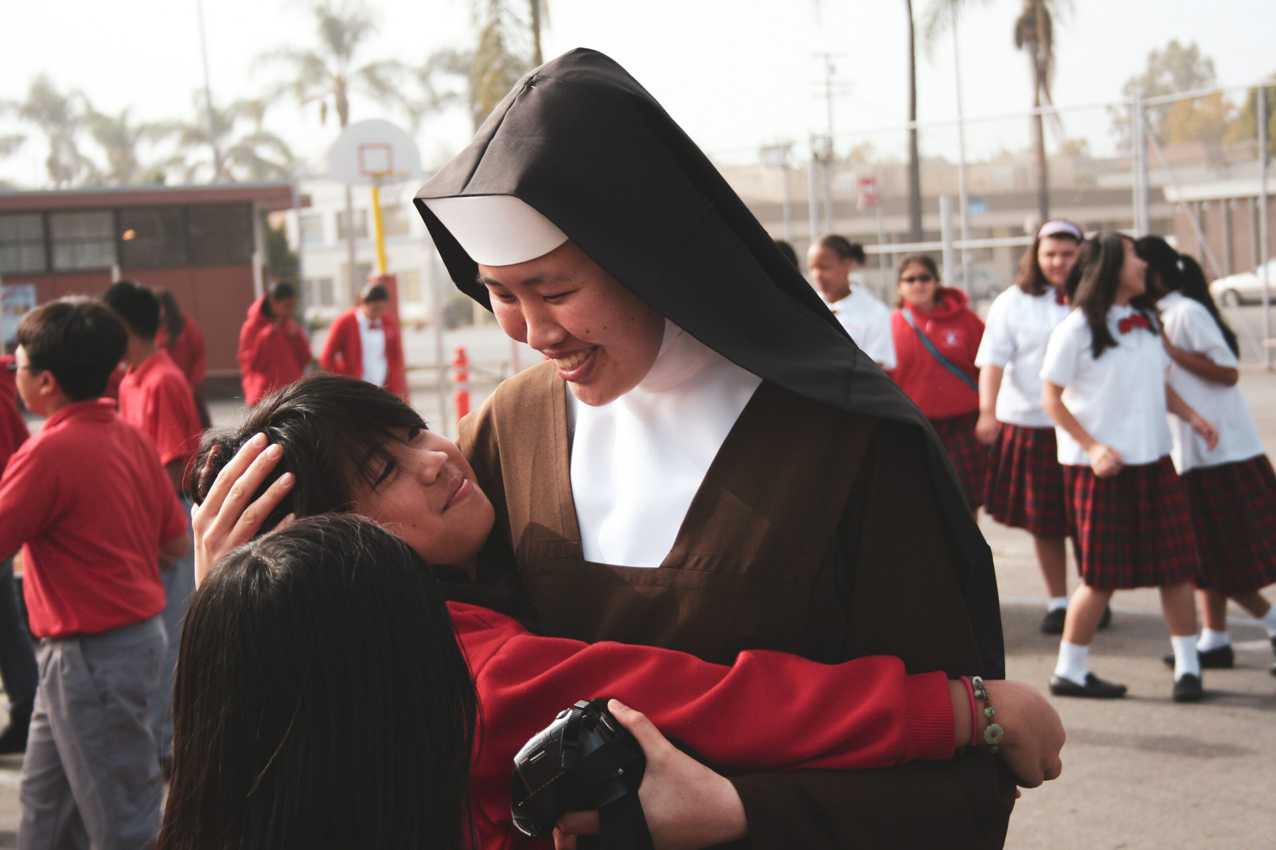 Student hugging a sister during school break