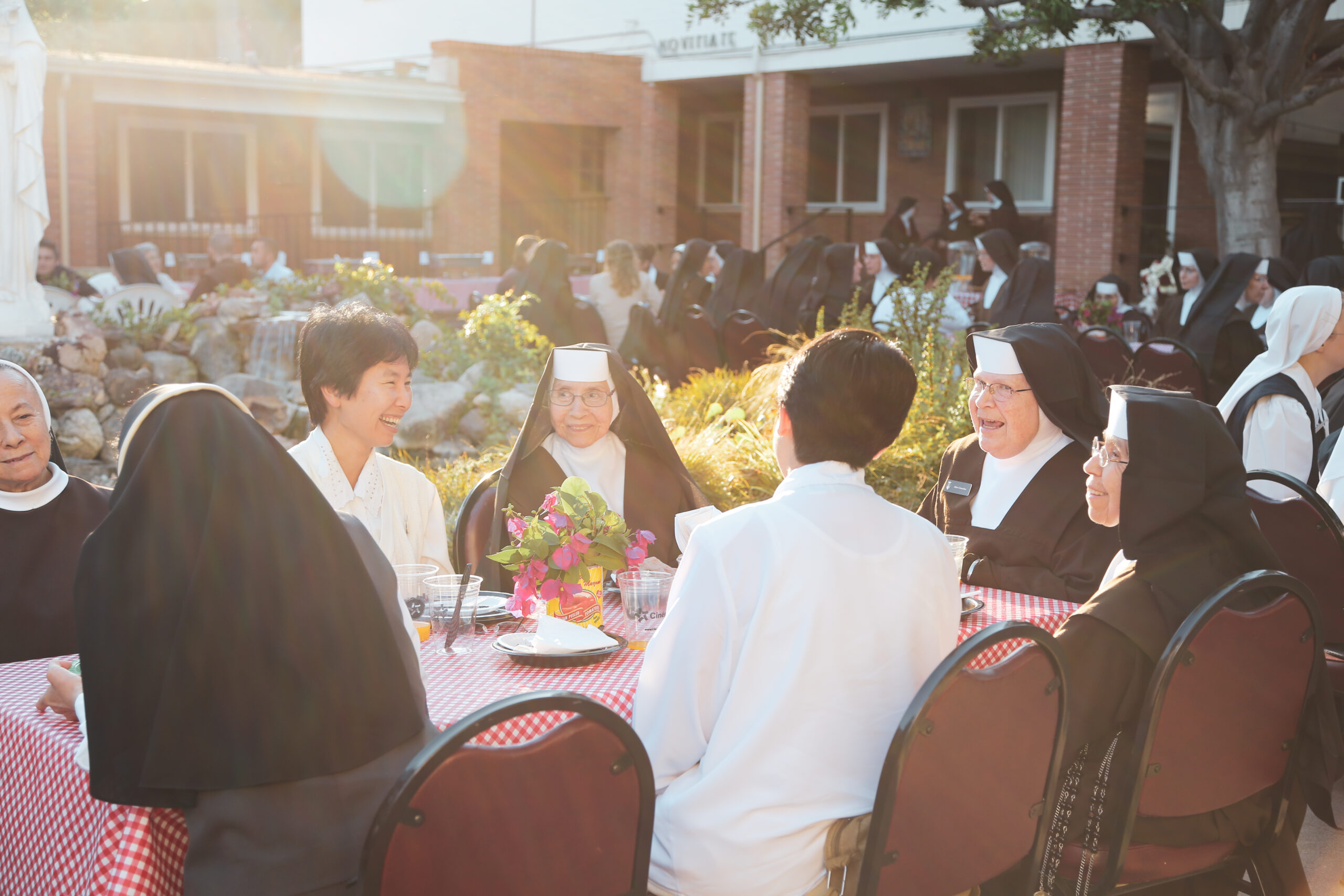 sisters_table_other_communities Lay and Sisters talking during a meal