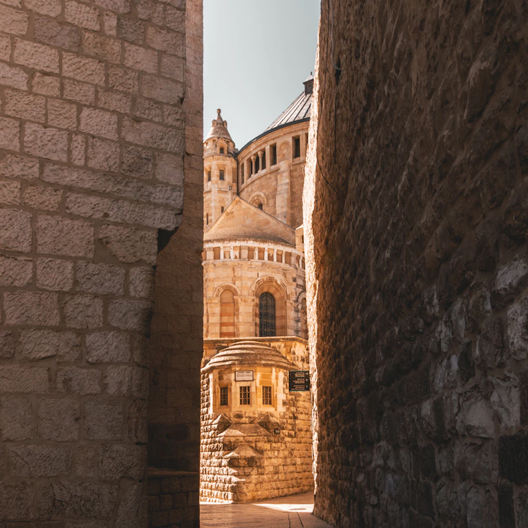 View through brick alley to stone church