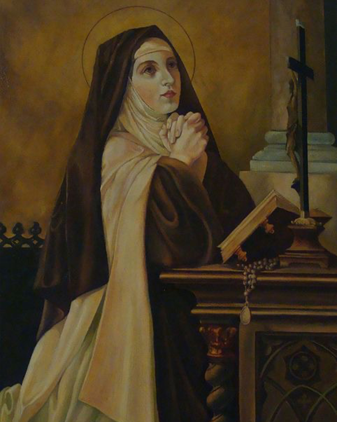 St. Teresa of Avila kneeling before a small crucifix, halo behind her head and open bible in front of her.