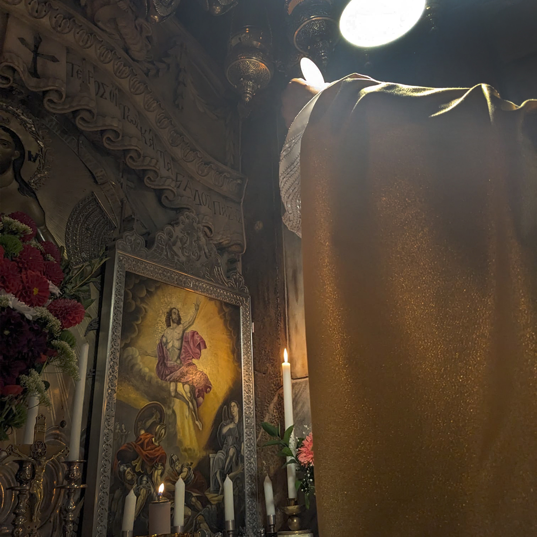 A priest holding up the Eucharist to the tabernacle.