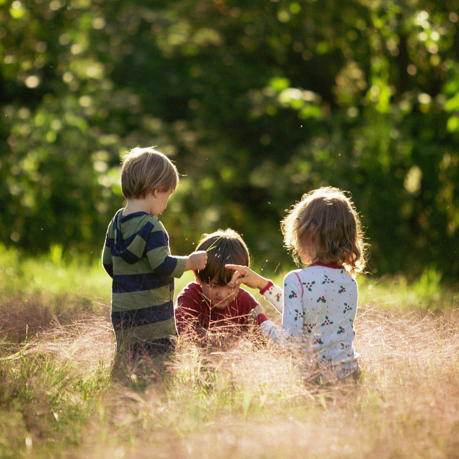 Sister sitting with children as they sing during mass.